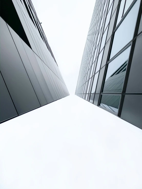 two buildings facing each other and one is looking up