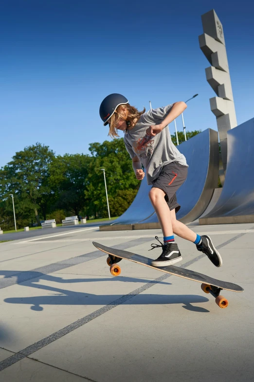 a person riding a skateboard next to a statue