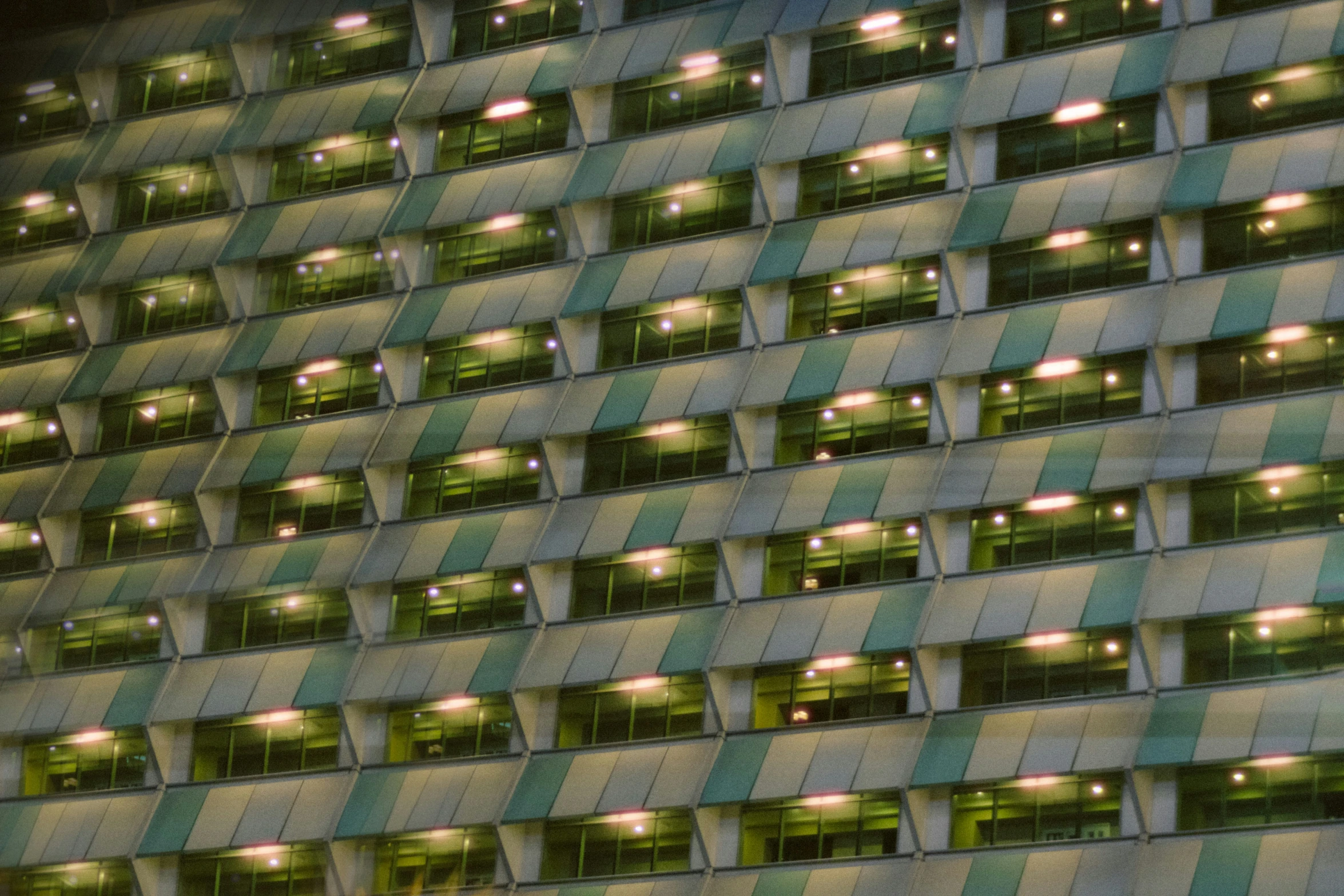 an apartment building with green and yellow windows