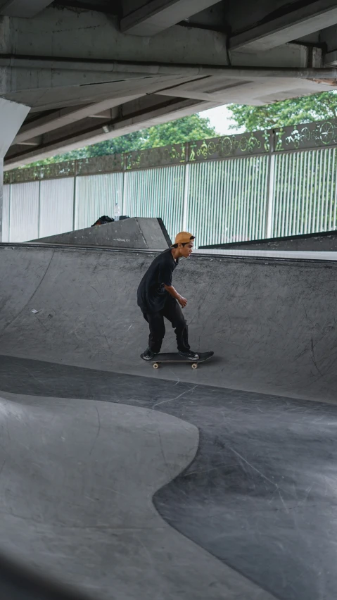 man riding a skate board in a skate park