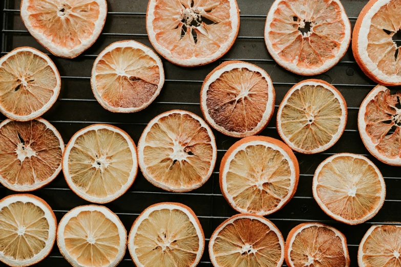 orange slices being cooked on a grill rack