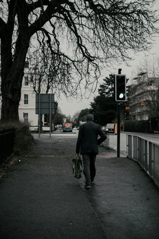 a person holding a bag walking down a sidewalk