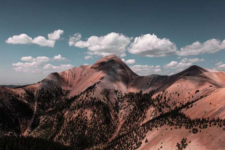 there are mountains near each other and clouds in the sky