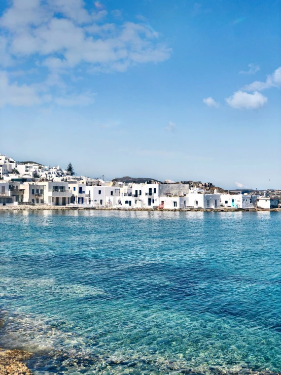 a few white buildings near the water