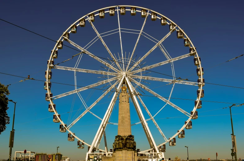 a ferris wheel sitting on top of a tall white building