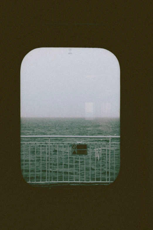 the view out the back window of a train at sea