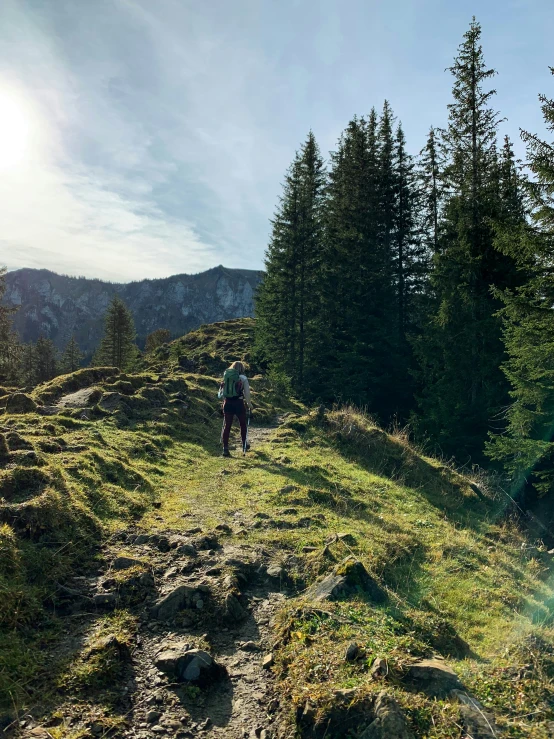 a person is hiking up the trail in the mountains