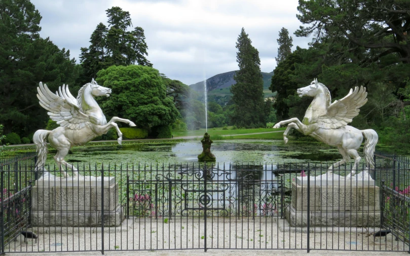 two statues of two horses in a fountain