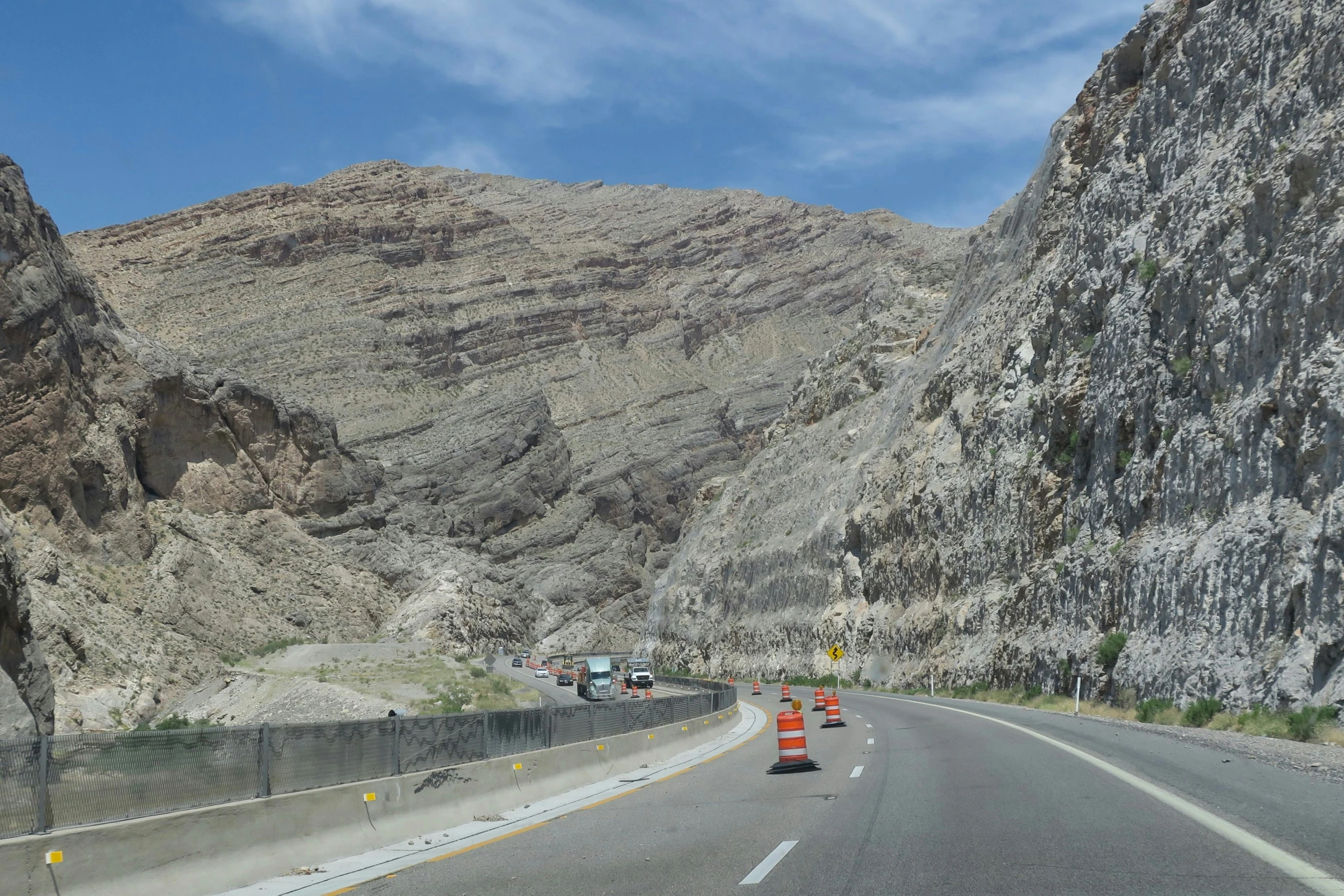 two lane highway with steep hills and a bridge