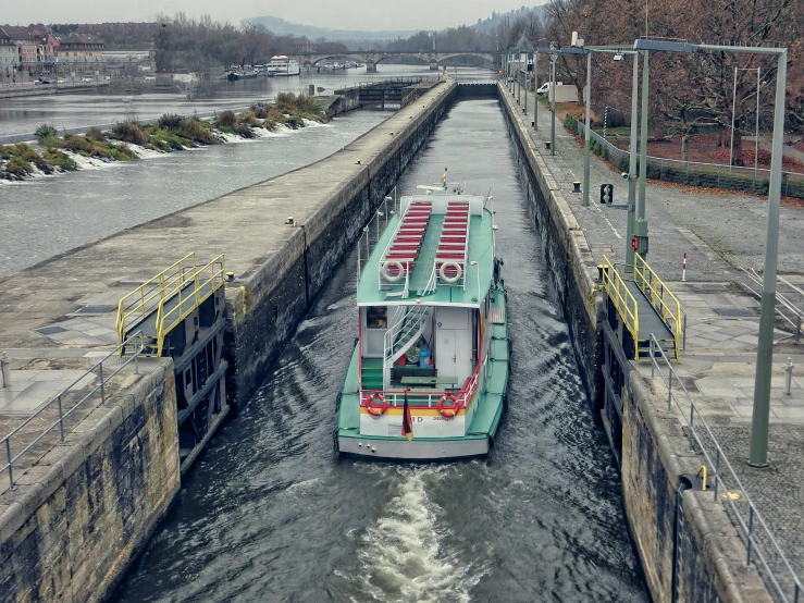 the barge is approaching the smaller one in the canal