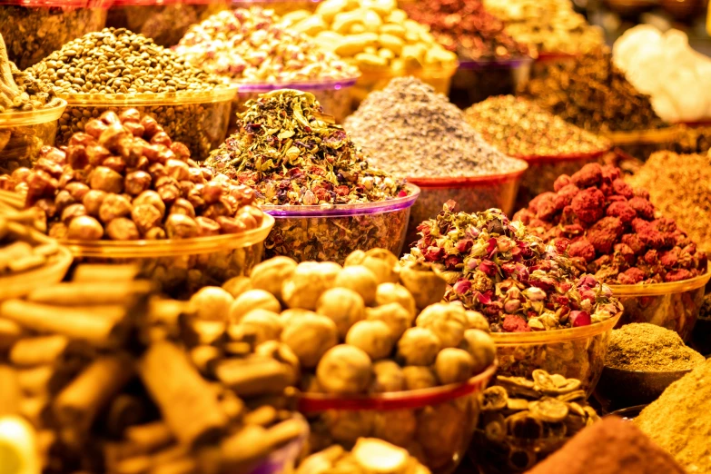 bowls with different spices, nuts and other food items