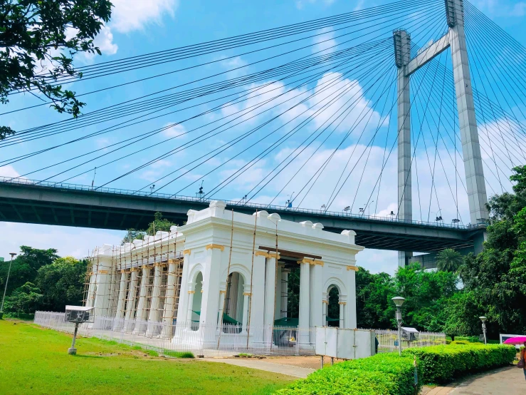 an empty walkway under the bridge and in front of it