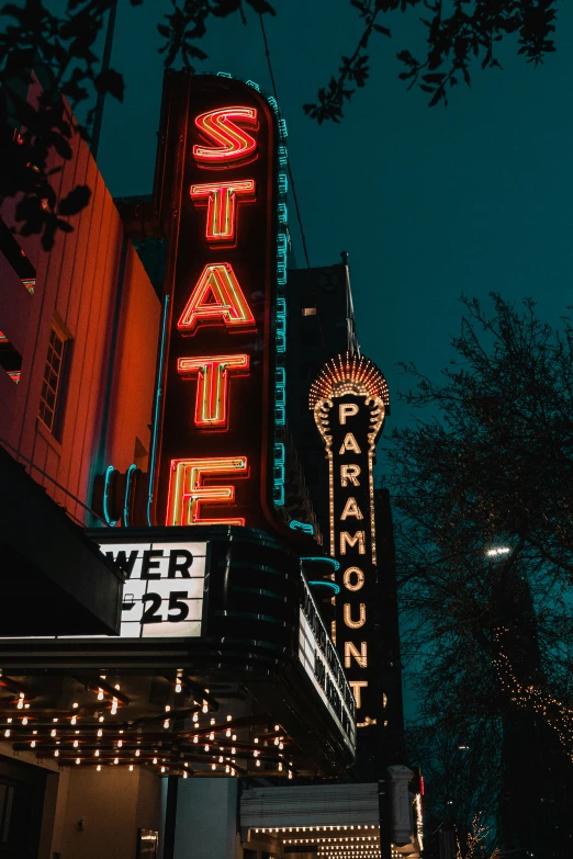 a picture of the piker theater at night with the neon lights on