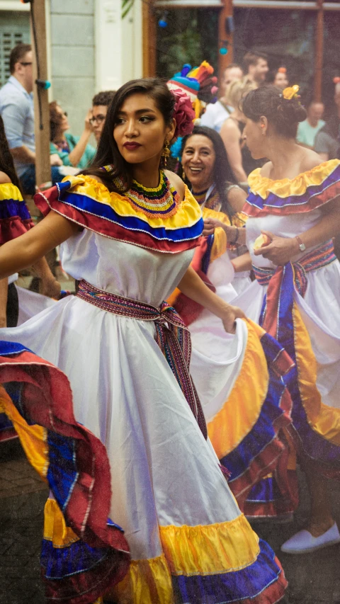 a colorfully dressed woman wearing a dress and head scarf