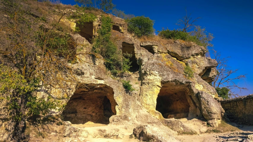 an outdoor area with a large rocky formation in the middle