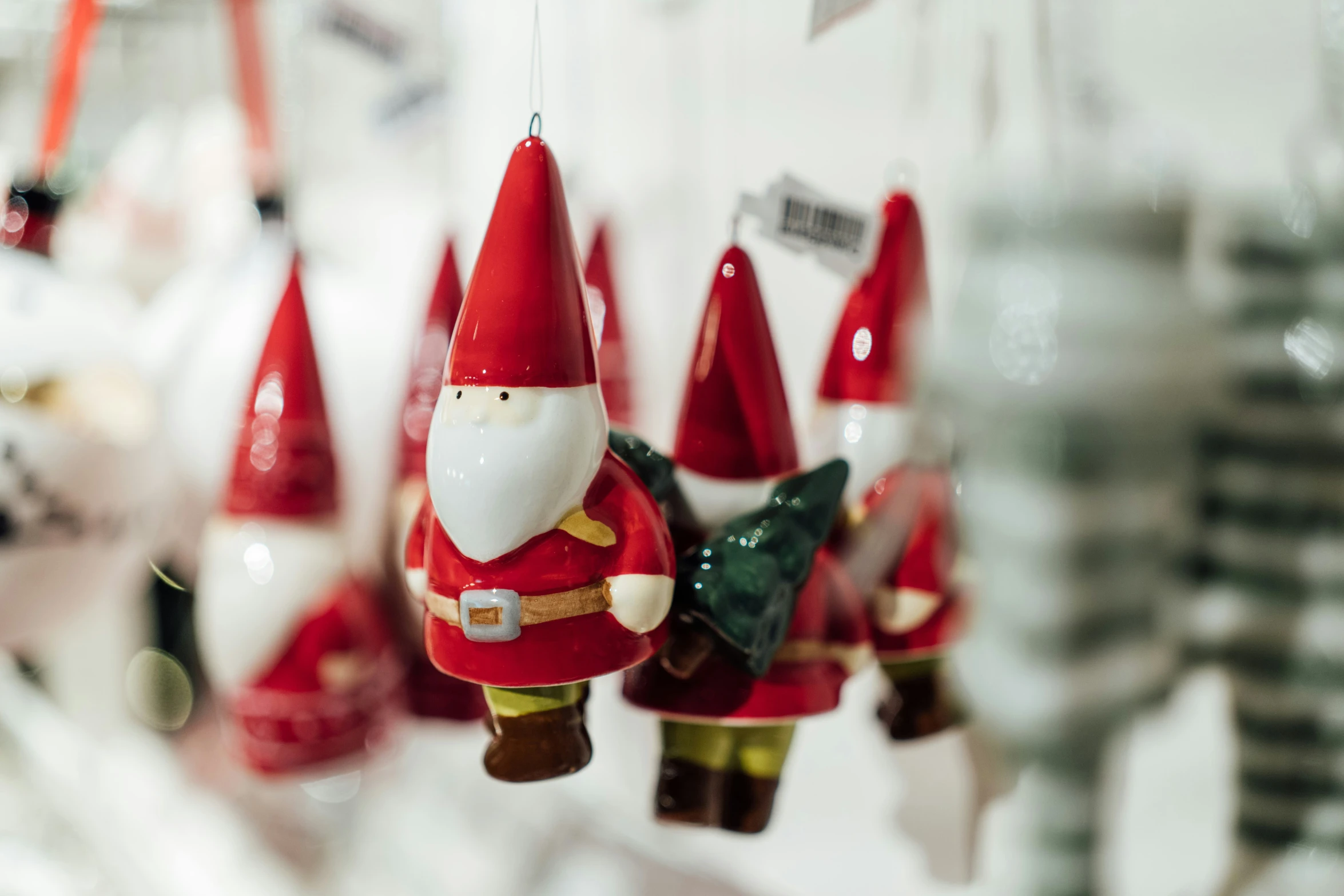 a collection of christmas ornaments hanging in various colors