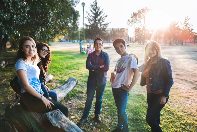 four young adults are gathered at the park