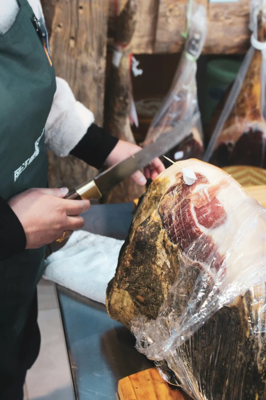 a man preparing food with meat and butcher knife