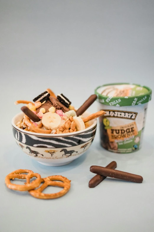 a white bowl filled with cereal next to some pretzels