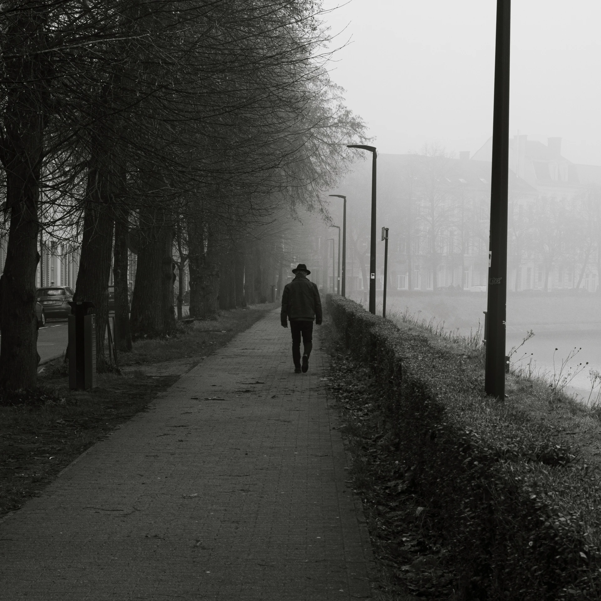 a man is walking down a walkway in the dark