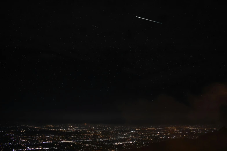 an image of the night sky that has the lights from buildings and cars