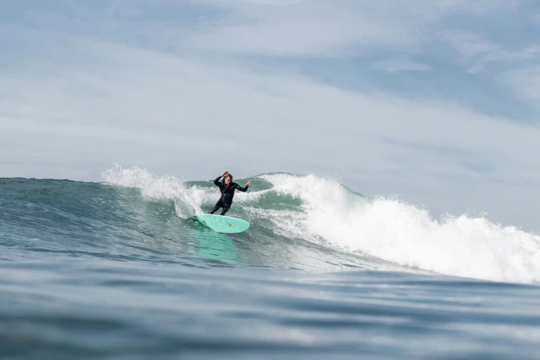 person on a surfboard rides on a wave