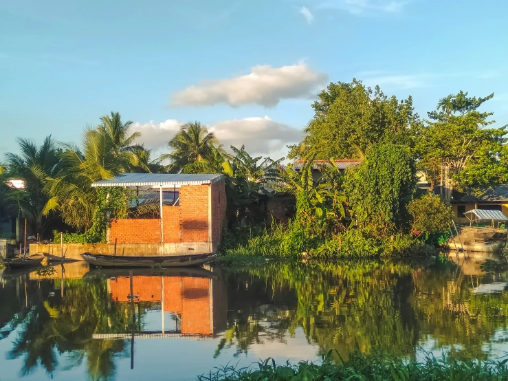 the small house boat is on the river bank