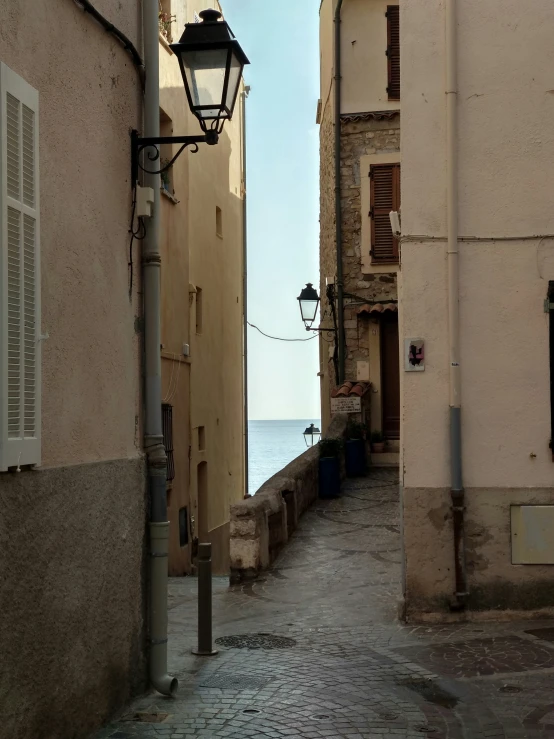 alleyway between two buildings and a light post