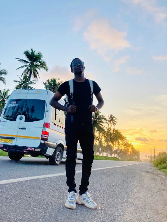 a man standing on the road next to an ambulance