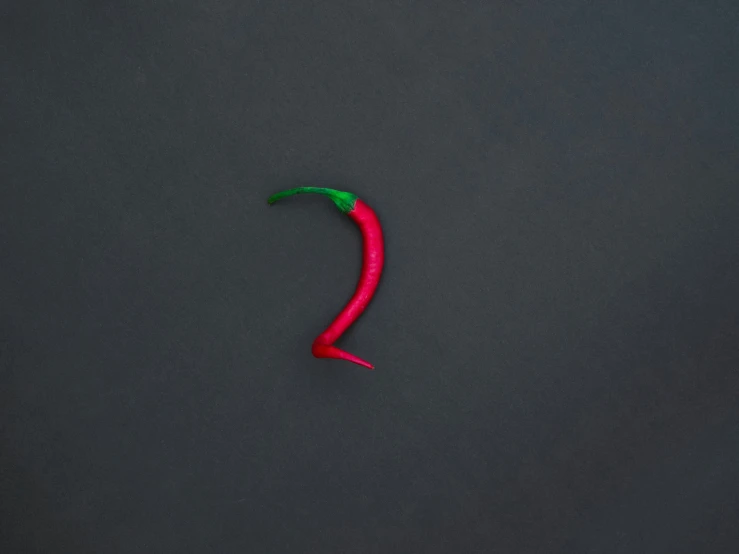 a chili on the side of a black background