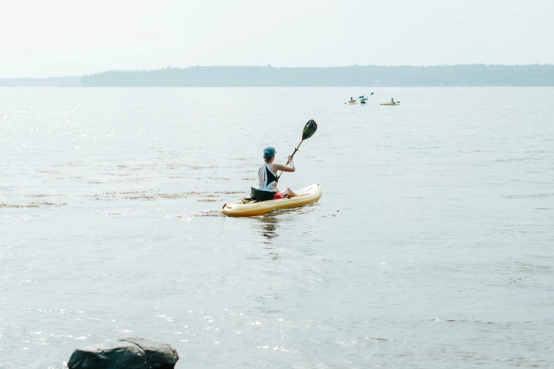 a man that is sitting in a kayak in the water