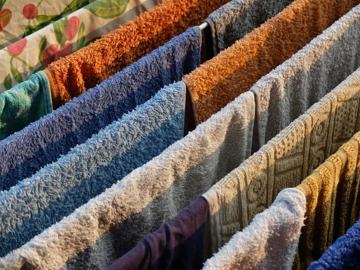 close up view of the various colored towels drying on the line