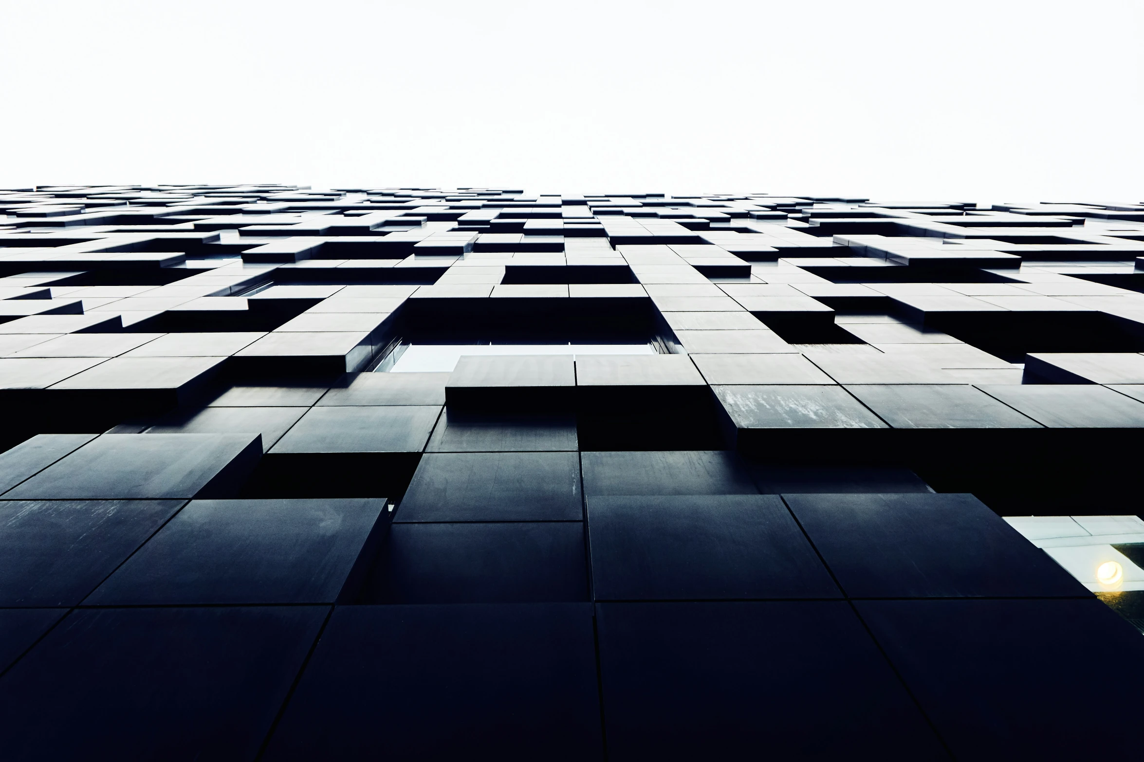 a very tall building with some interesting black cubes on it