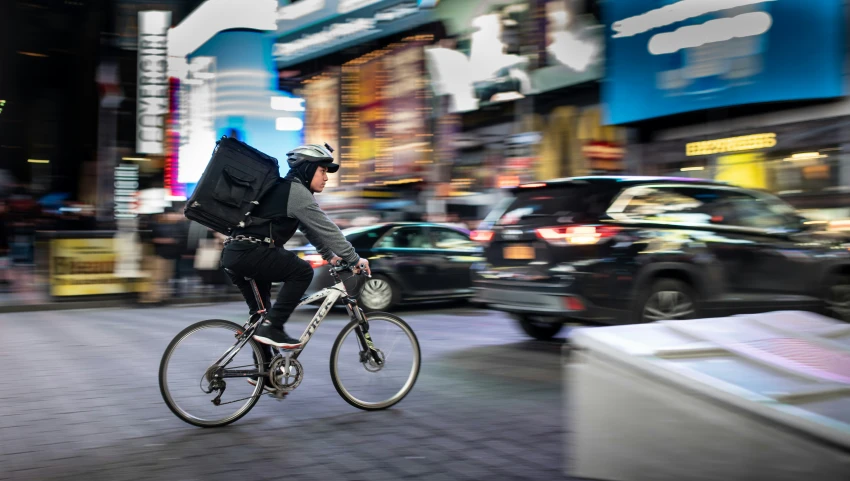 a man riding a bike down a city street