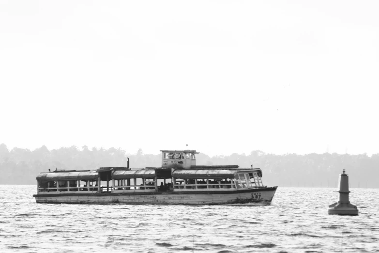 the boat is sailing past the light pole on the water