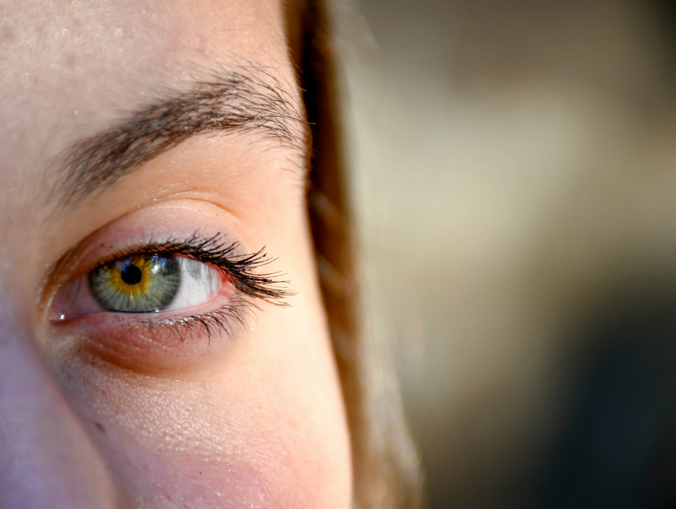 a close up of an eye and a woman's face