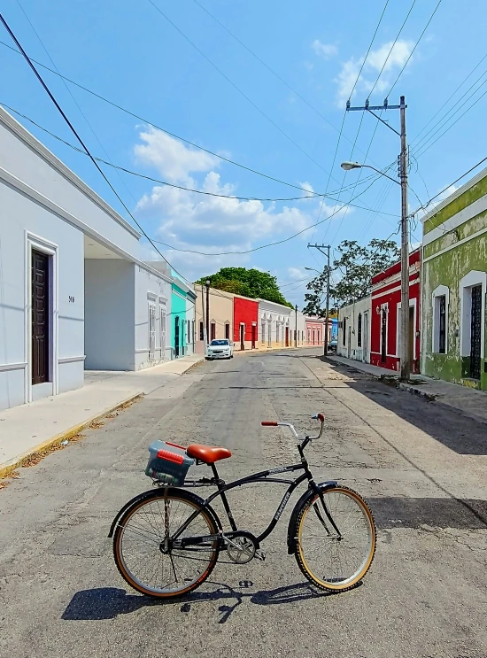 a bike that is on the road by buildings