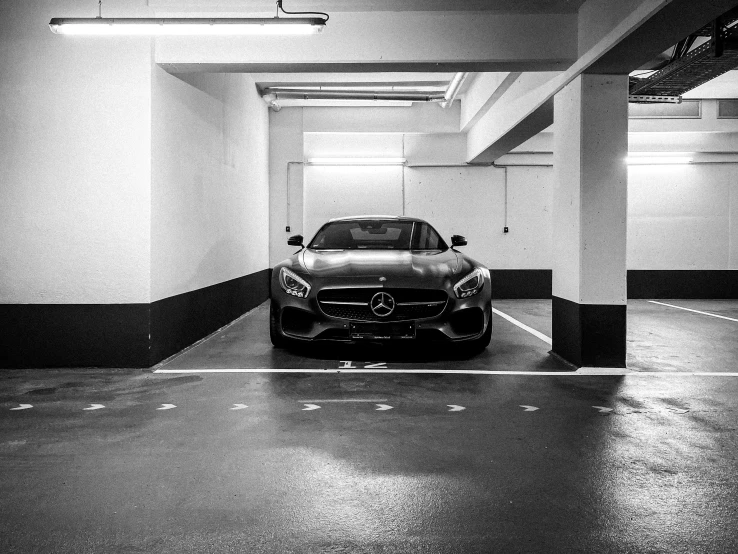 a modern car parked in an empty parking garage