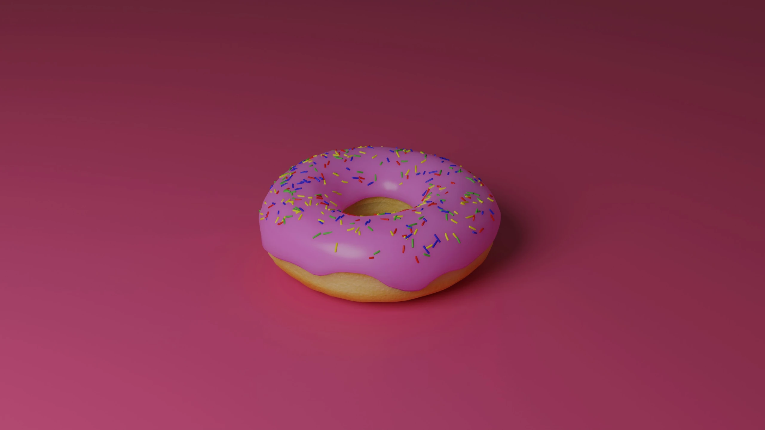 a donut on the ground has been pastel pink with colorful sprinkles