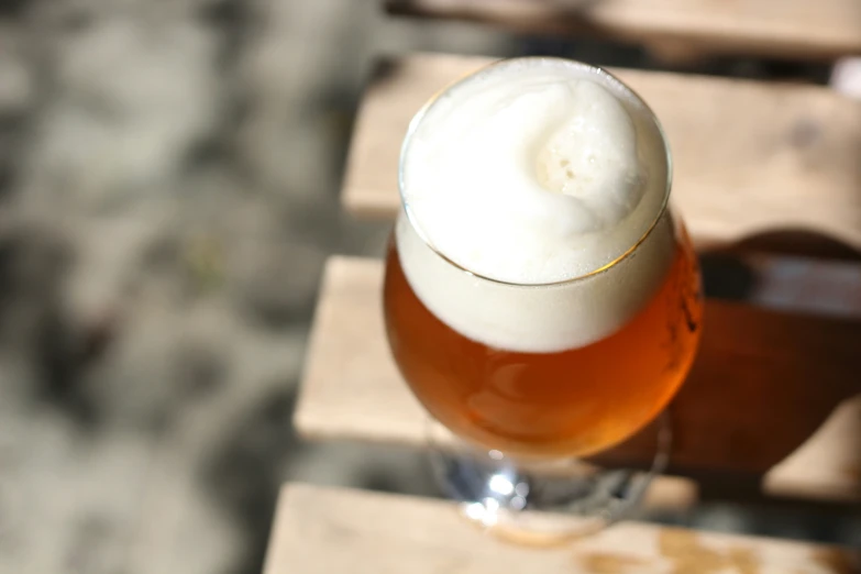 a close up of a beer with foam on the top