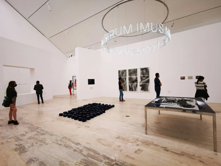 people in a museum looking at artwork on display