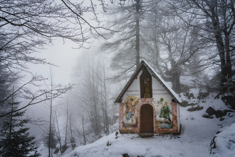 a decorated cottage on a snowy mountain side