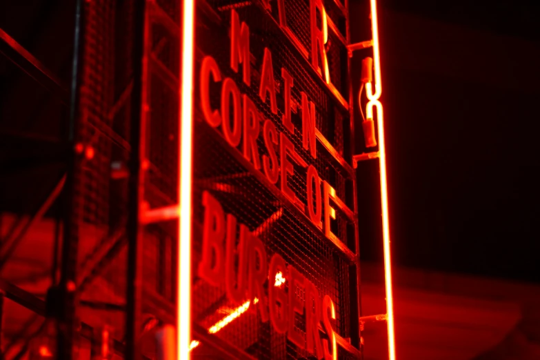 neon signs sitting in a row with dark background