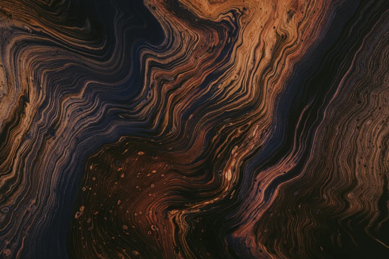 closeup image of earth surface with layers of marbled wood