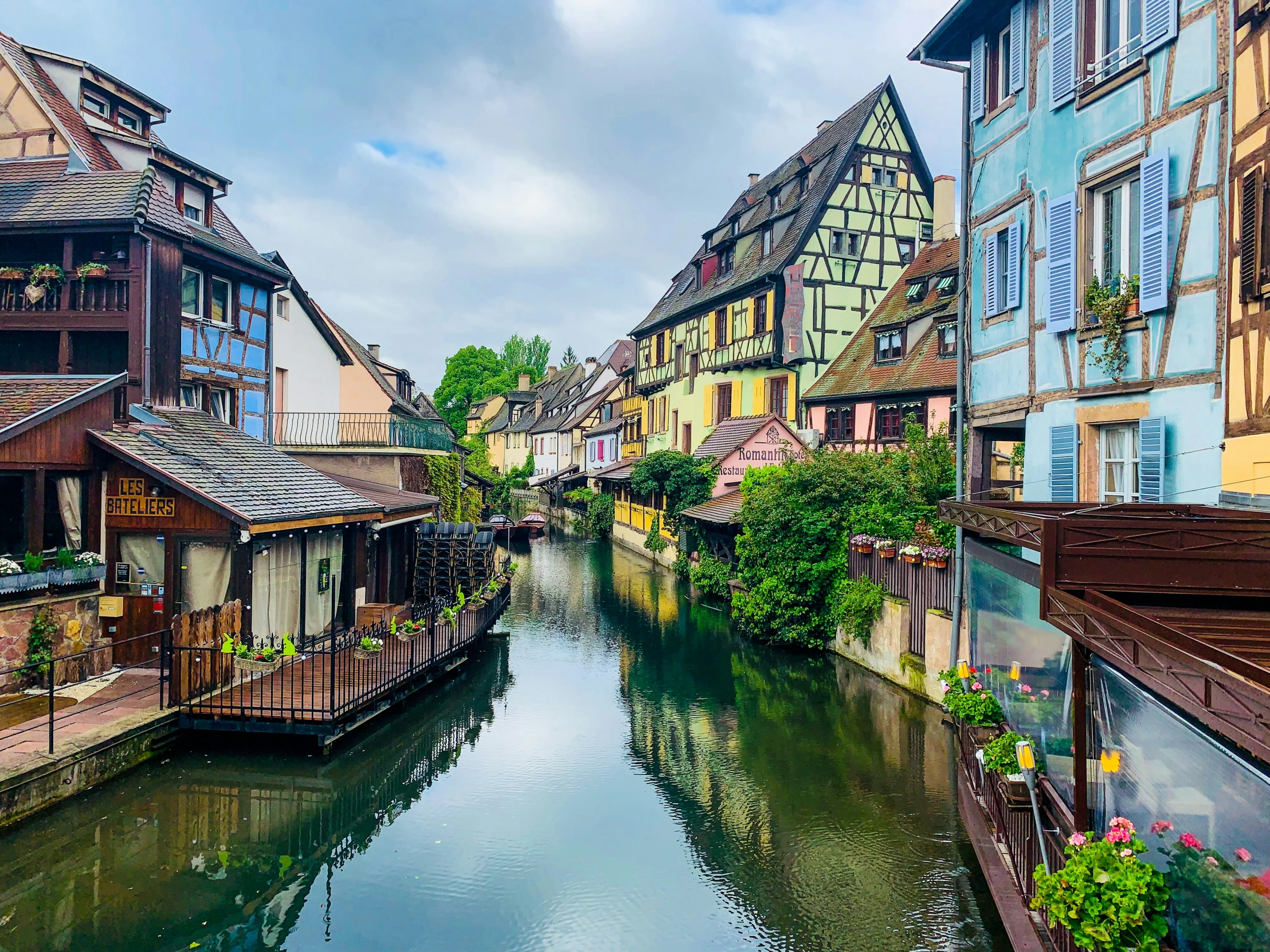 a canal with small boats and old houses in it