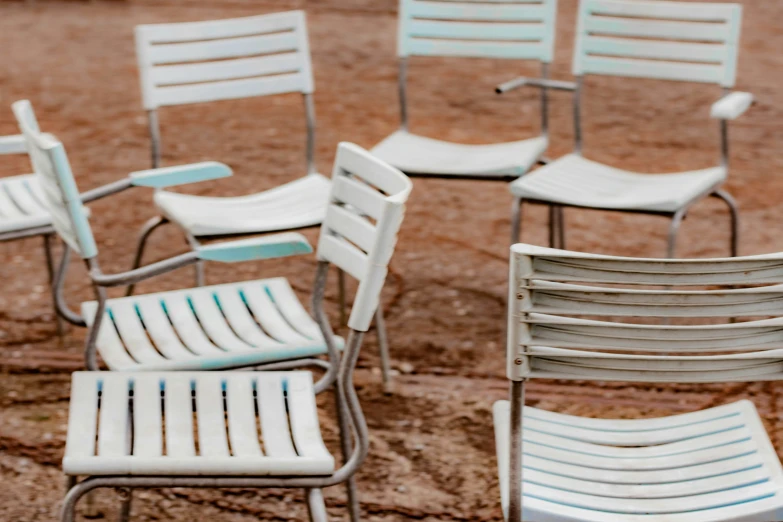 many empty chairs, many leaning against each other