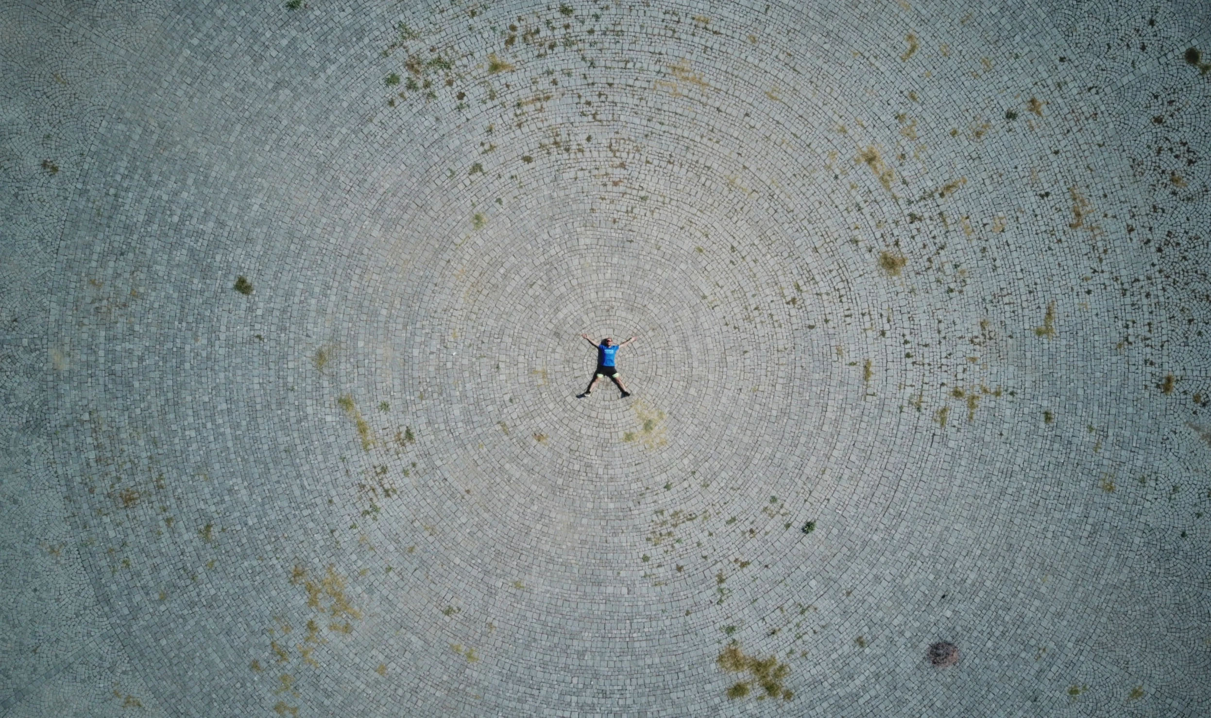 person walking in the desert with one foot up