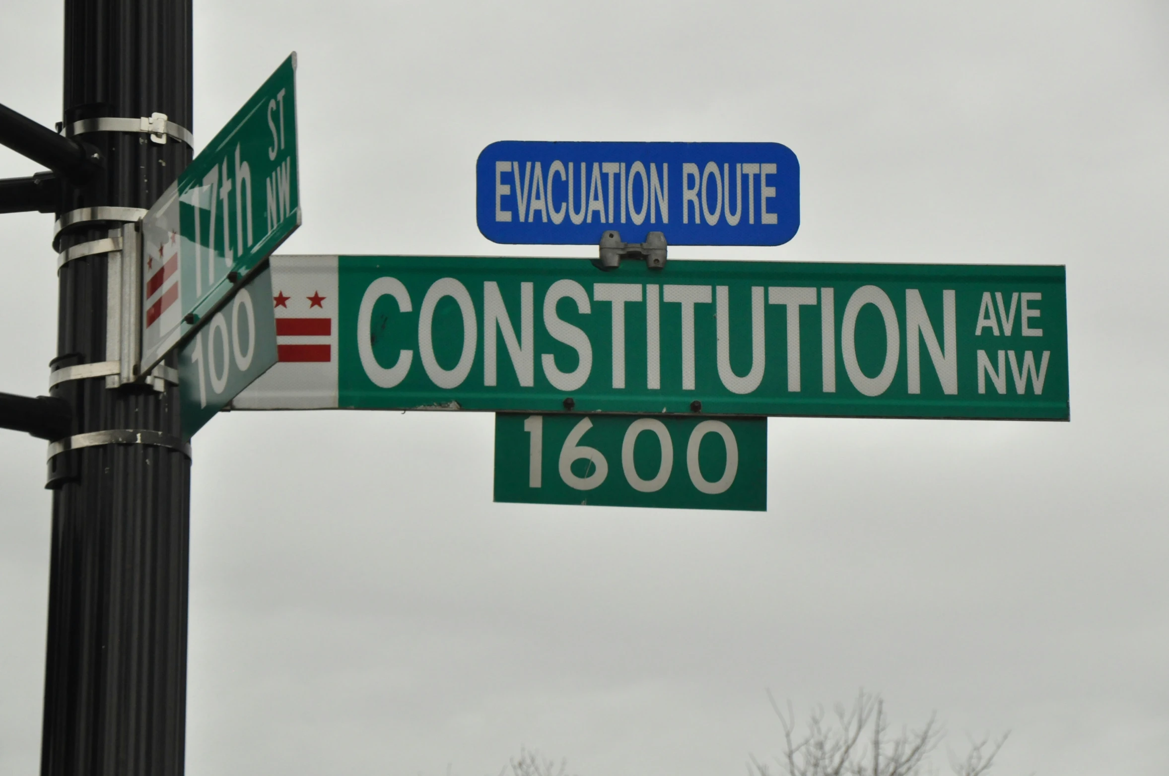 a couple of street signs hanging from a metal pole