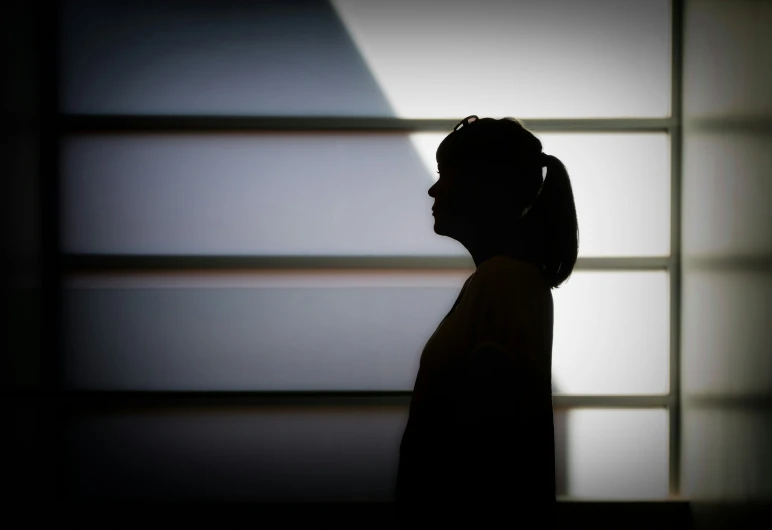 a woman in a black jacket is talking on a phone