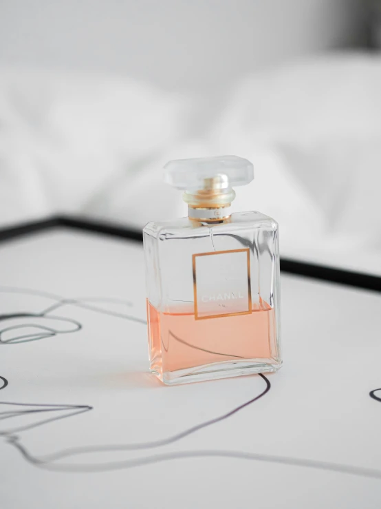 a close up of a small bottle on the bed